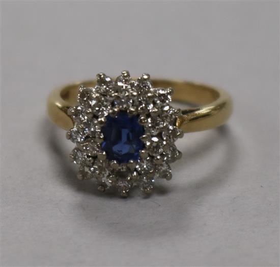 A sapphire and diamond cluster ring, 18ct gold setting, size K.